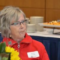 An alumna sitting at a table